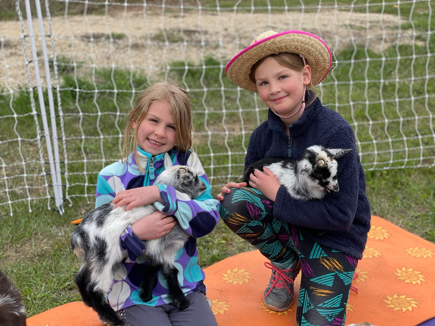 Two girls with baby goats